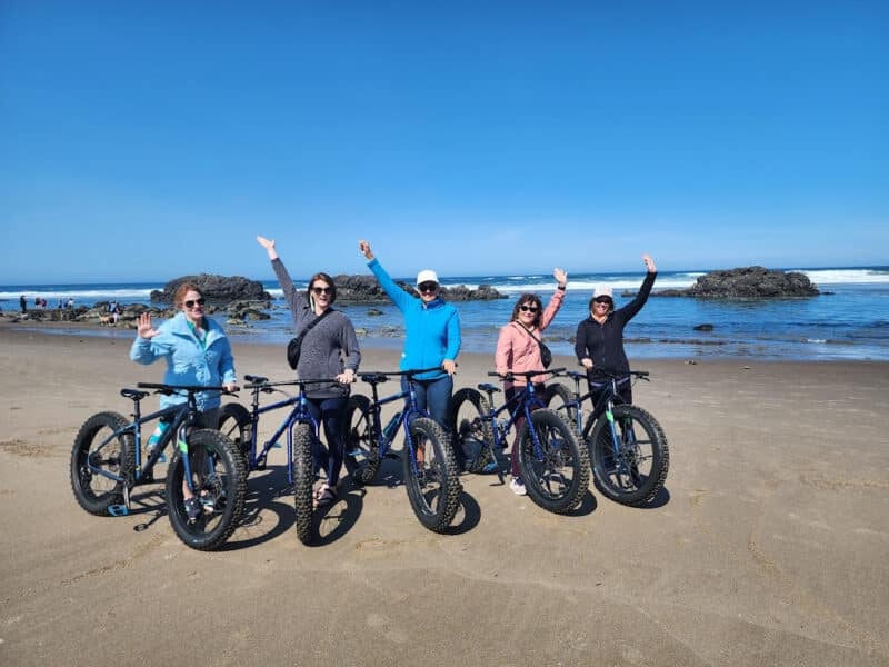 Women biking along one of Oregon’s beaches – Canyon Calling Adventures Costa Rica