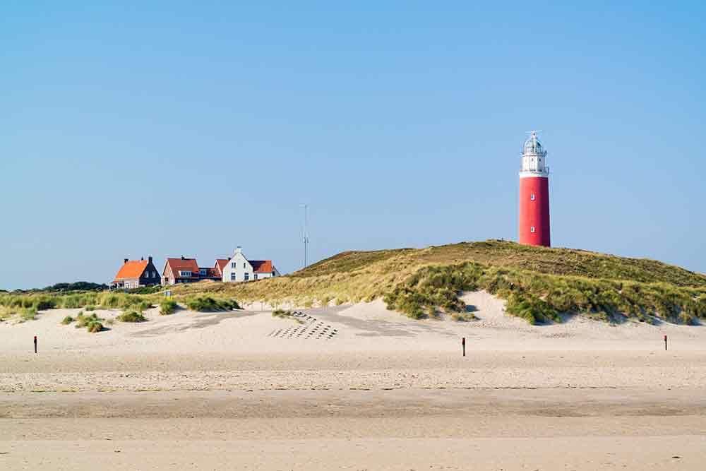 Beach and lighthouse De Cocksdorp Texel Netherlands